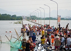 Trẻ em thoả thích bơi lội trên... đường tỉnh lộ ở Hà Nội