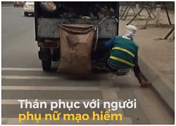 Người phụ nữ đu bám trên đuôi xe tải để nhặt rác ven đường khiến mọi người hoảng hồn