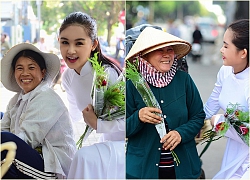 Lê Âu Ngân Anh mặc áo dài trắng, xuống phố tặng hoa cho phụ nữ lao động nhân ngày 8/3