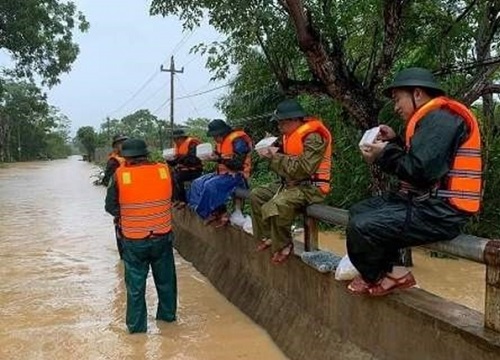 Nụ cười tỏa nắng của chiến sĩ trẻ khi giải cứu em bé khỏi nhà ngập lụt