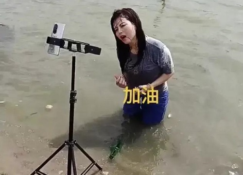 Lăn lê trong hồ nước cạn để livestream giả vờ đang ở vùng mưa lũ, nhóm truyền thông bất lương nhận đủ "gạch đá" từ cư dân mạng