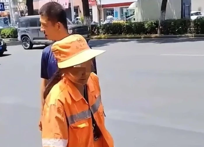 Người mẹ lao công dẫn con trai thiểu năng trí tuệ nhặt rác giữa trời nắng